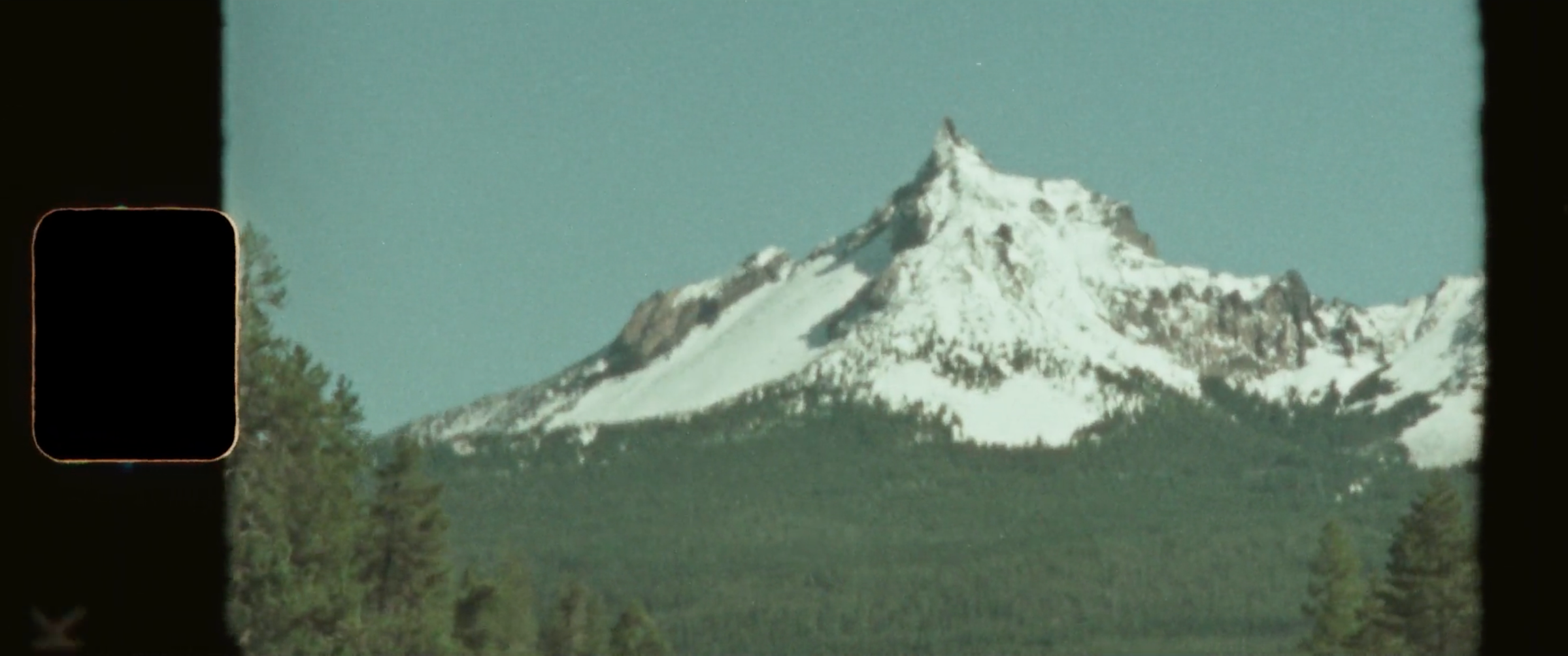 Super 8 frame of a snow-capped Oregon peak