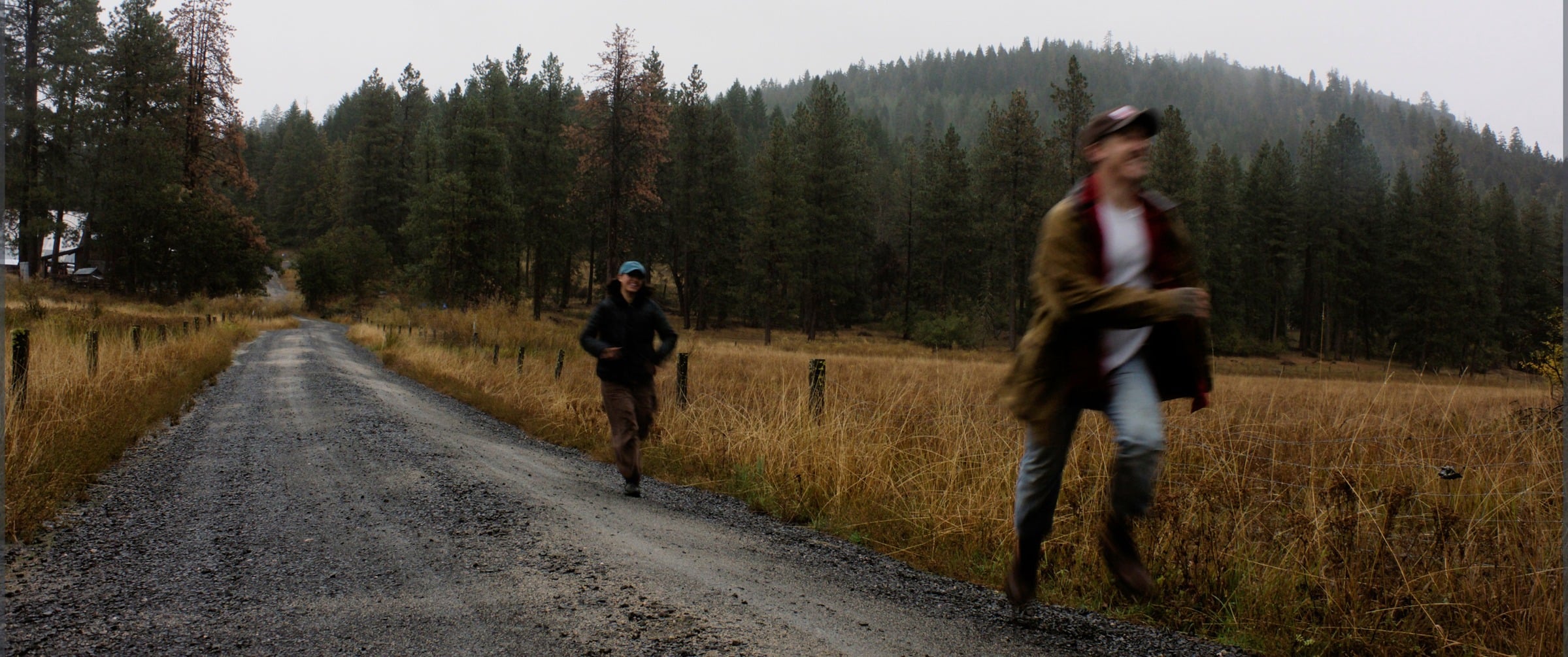 Margot and Julian walking a gravel road through the Oregon high country
